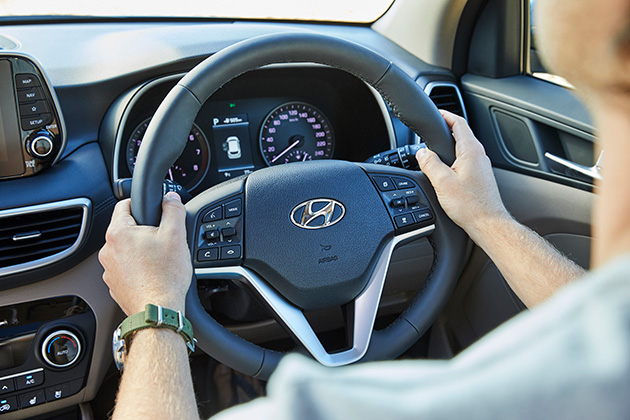 Man Holding Hyundai Steering Wheel
